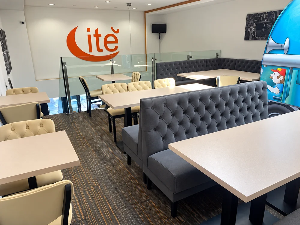 De zitruimte van Frituur Cité, met comfortabele banken en tafels